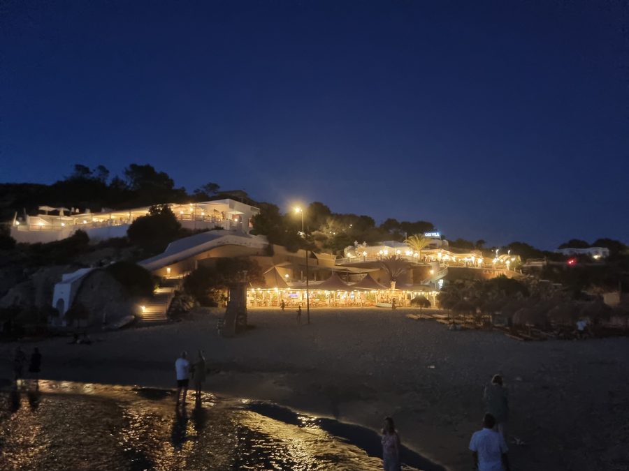 Gebäude entlang der Küste von Cala Tarida auf Ibiza, von einem Felsbecken aus gesehen